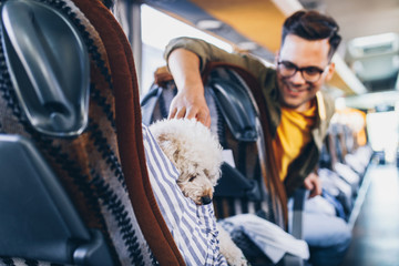 Passengers and dog traveling by bus.