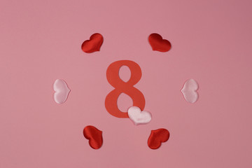 March 8. Women's day. Number 8 on a pink background with hearts.