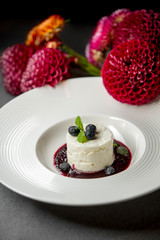 dessert with dark pink sauce on a gray background with flowers