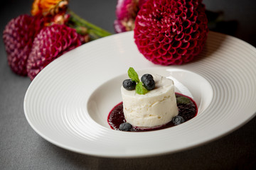dessert with dark pink sauce on a gray background with flowers