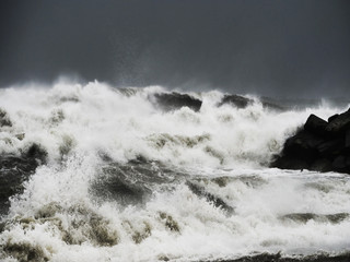 Sea storm with splash from big waves over cliffs