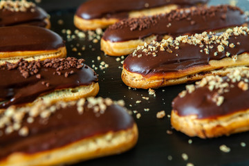  Traditional french eclairs with chocolate. Tasty dessert. Home made cake eclairs  Sweet. Dessert. Pastry filled with cream. Chocolate icing.