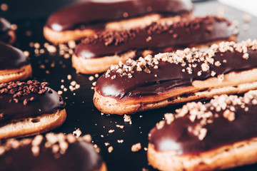  Traditional french eclairs with chocolate. Tasty dessert. Home made cake eclairs  Sweet. Dessert. Pastry filled with cream. Chocolate icing.