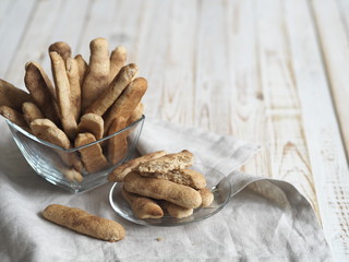 Homemade shortbread biscuits with cinnamon and nuts on a white wooden table. We bake cookies.