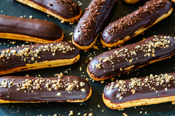  Traditional french eclairs with chocolate. Tasty dessert. Home made cake eclairs  Sweet. Dessert. Pastry filled with cream. Chocolate icing.