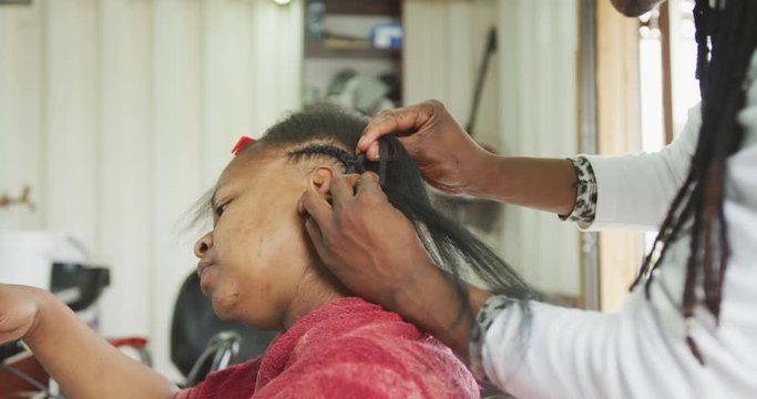 African man adding hair extensions
