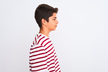Handsome teenager boy standing over white isolated background looking to side, relax profile pose...