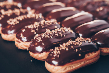  Traditional french eclairs with chocolate. Tasty dessert. Home made cake eclairs  Sweet. Dessert. Pastry filled with cream. Chocolate icing.