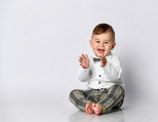 Happy baby. Little boy in a white shirt and bow tie. Children portrait. Stylish man in fashionable...