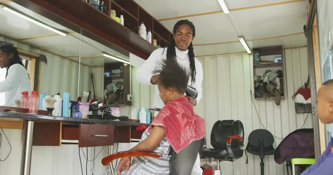 African man styling the hair of a African woman