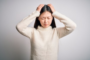 Young beautiful asian woman wearing casual sweater standing over isolated background suffering from...