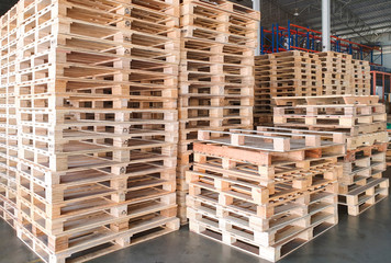 Stack of wooden pallets in interior warehouse.