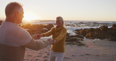 Happy senior couple at beach - Powered by Adobe