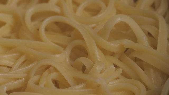 Close up texture shot of cooked spaghetti noodles plain.