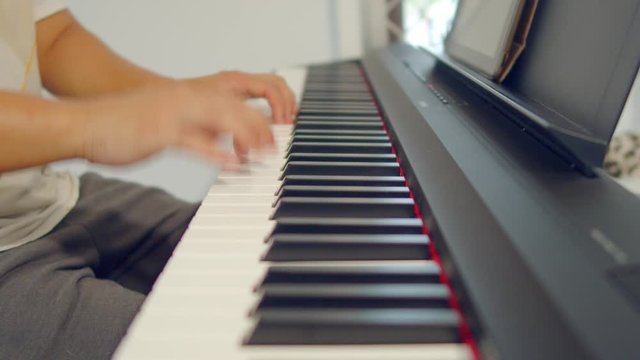 Male Hands Playing Piano. Musical Instrument Playing. Keyboard Instrument
close up shot of male practice playing digital keyboard
