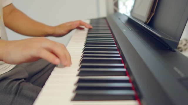 Male Hands Playing Piano. Musical Instrument Playing. Keyboard Instrument
close up shot of male practice playing digital keyboard