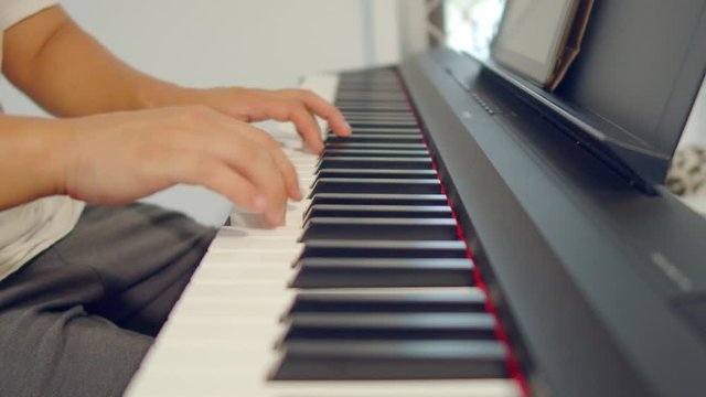 Male Hands Playing Piano. Musical Instrument Playing. Keyboard Instrument
close up shot of male practice playing digital keyboard