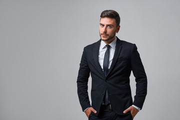 Close up portrait young man businessman. Caucasian guy business suit studio gray background.