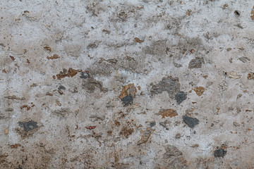 wall composed of large exposed stones with grey cement