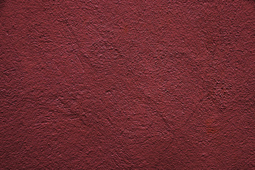 Texture of red crumpled paper. Uneven red surface texture