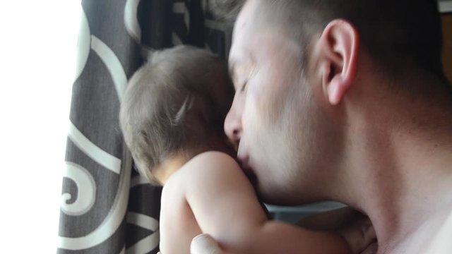 Baby and daddy bonding concept. A father is entertaining his son, making funny noises and face expressions. Close up