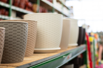 plastic flower pots, pots for indoor plants, garden tools store, shelves with flower pots