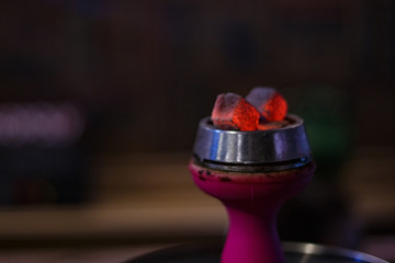 hookah bowl with embers on a dark background