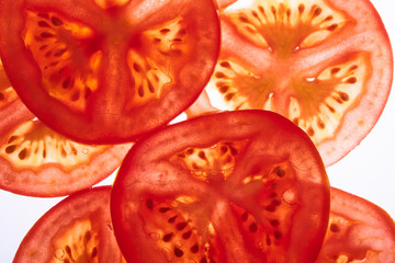 Fresh raw tasty sliced tomatoes isolated on white background