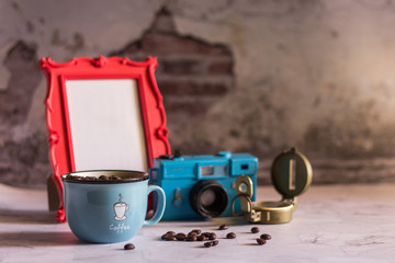 Black coffee in Blue cup on freshly roasted coffee beans background. Top view.