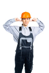 Female construction engineer does not want to hear anything. The construction site is working loudly. Isolated