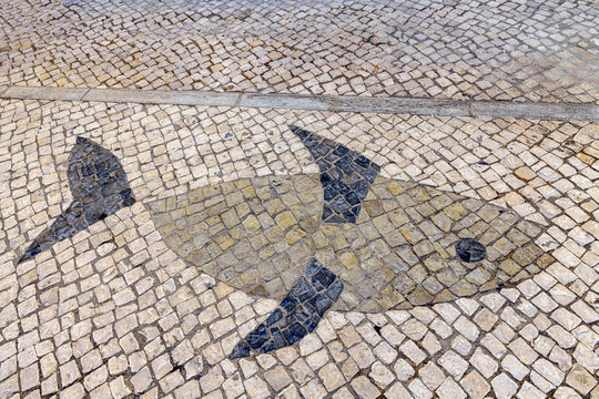 09.18.2019. Fuseta, Algarve, Portugal. Fish pattern in traditional Portuguese cobble stones.