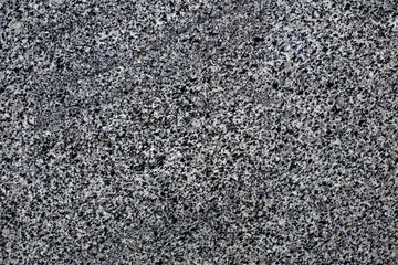 Old stone background from gray granite, for advertising construction services or asphalt texture