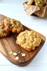 Home made oatmeal cookies with chocolate drops on a wooden board in the kitchen.