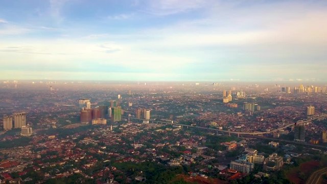Birds view of buildings around Cilandak, Jakarta. A drone footage in the morning with cityscapes and mountains view