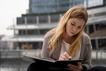 Fototapeta premium Blonde Teenager Studying and Reading Outside