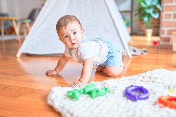 Beautiful toddler crawling at kindergarten