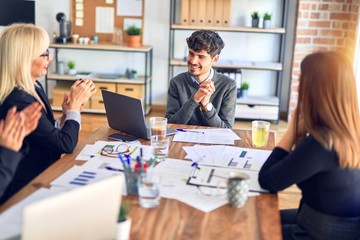 Group of business workers smiling happy and confident. Working together with smile on face applauding one of them at the office