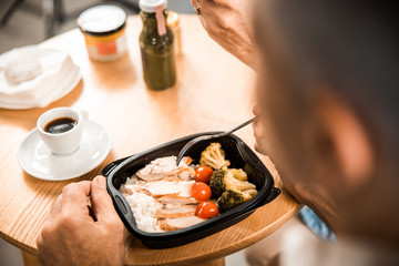 Top view of man having lunch in cafe