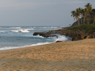 Sunset on tropical beach. Scenic landscapes of a cliff.