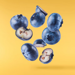 Fresh raw blueberries falling in the air.