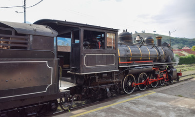 Fototapeta na wymiar Steam train locomotive stopped at the station in the city of Passa Quatro, state of Minas Gerais, Brazil