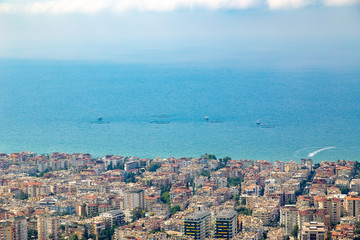 Fishing at the sea near the urban region. Several fishing boats with open water nets during fishing.