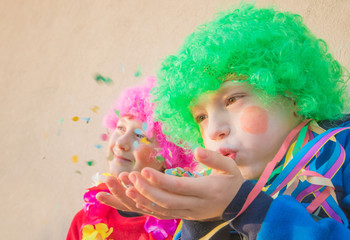 Funny Children girls celebrate carnival smiling and having fun with  colorful confetti