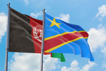 Congo and Afghanistan flags waving in the wind against white cloudy blue sky together. Diplomacy concept, international relations.