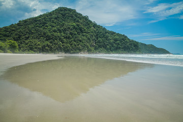 Praia de Itamambuca, Ubatuba, Sao Paulo, Brazil - Paradise tropical beach with white sand, blue and calm waters, without people on a sunny day and blue sky of the Brazilian coast in high resolution