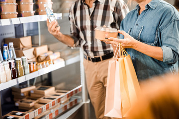 Adult couple is choosing products together in shop