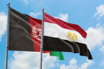 Egypt and Afghanistan flags waving in the wind against white cloudy blue sky together. Diplomacy concept, international relations.