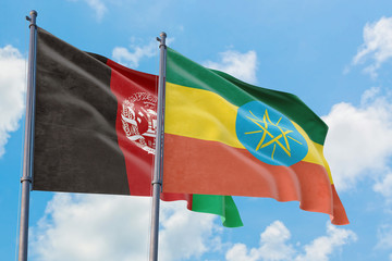 Ethiopia and Afghanistan flags waving in the wind against white cloudy blue sky together. Diplomacy concept, international relations.