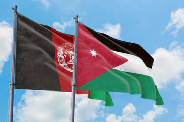 Jordan and Afghanistan flags waving in the wind against white cloudy blue sky together. Diplomacy concept, international relations.