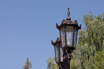 Fototapeta na wymiar Forged night lantern in daylight against the sky